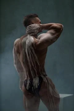Back view of shirtless athletic strong man at studio Stock Photos