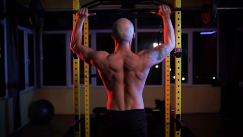Back view of Shirtless Man Lifting Barbell Stock Footage 146731591