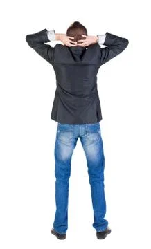 Back view of shocked and scared young business man. Holds hands Stock Photos