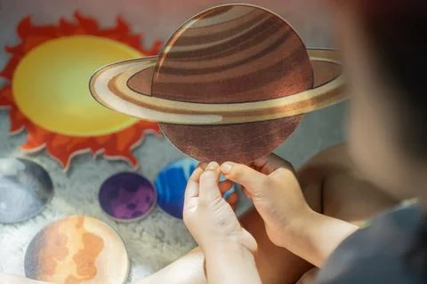 Back view shot of child exploring the solar system with a Hands-on Paper Mode Stock Photos