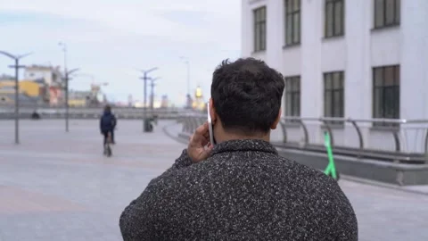 Back view shot of Indian man talking on mobile phone Stock-Footage 152108565