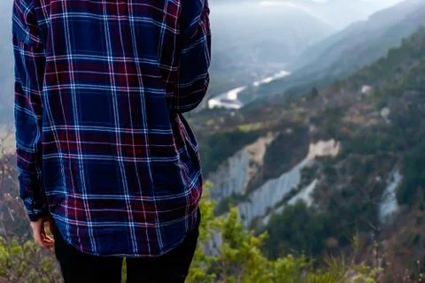 A back view shot of an unrecognizable young female hiker / adventurer who is  Stock Photos