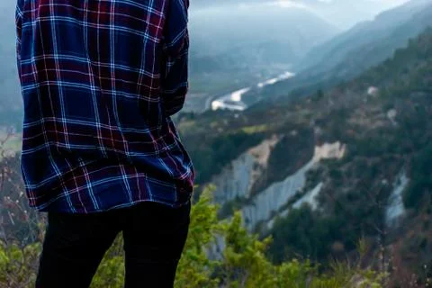 A back view shot of an unrecognizable young female hiker / adventurer who is  Stock Photos