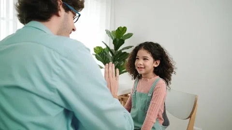 Back view of smart father explain about prompt and giving high five. Pedagogy. Stock Footage 270830640