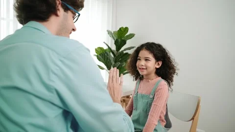 Back view of smart father explain about prompt and giving high five. Pedagogy. Stock Footage 278127306