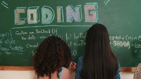 Back view of smart student writing coding engineering prompt at board. Pedagogy. Stock Photos