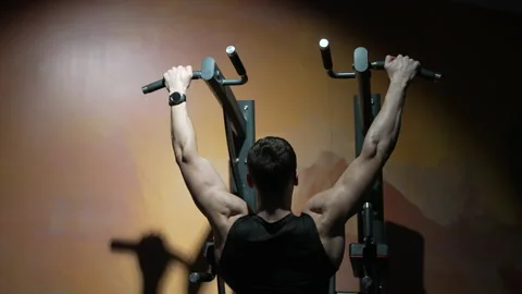 Back view of sportsman do pullup workout in sport gym. sport sportsman with Stock Footage 223853514