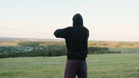 Back view of an Sporty man doing morning exercise in the park. Stock Footage 141448707