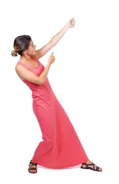 Back view of standing girl pulling a rope from the top or cling Stock-Fotos