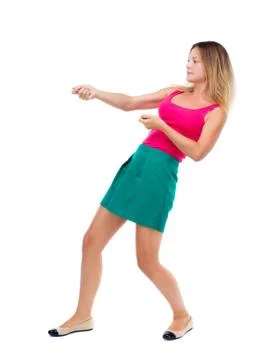 Back view of standing girl pulling a rope from the top or cling Foto stock