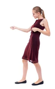 Back view of standing girl pulling a rope from the top or cling Stock-Fotos