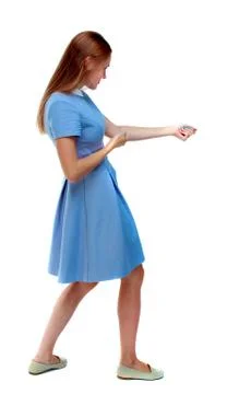 Back view of standing girl pulling a rope from the top or cling Foto stock