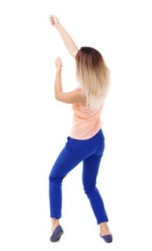 Back view of standing girl pulling a rope from top or cling to s Stock-Fotos