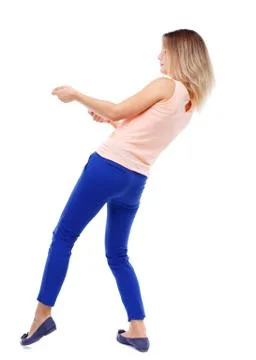 Back view of standing girl pulling a rope from top or cling to s Foto stock