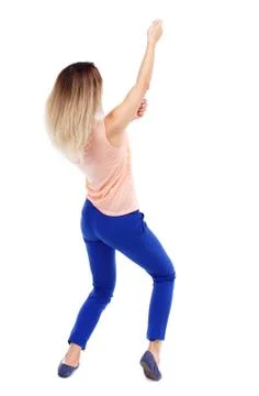 Back view of standing girl pulling a rope from top or cling to s Stock-Fotos