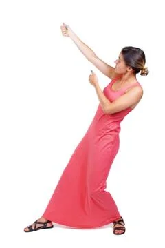 Back view of standing girl pulling a rope from the top or cling Foto stock