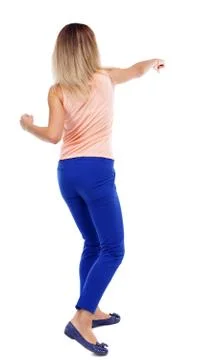 Back view of standing girl pulling a rope from top or cling to s Stock Photos
