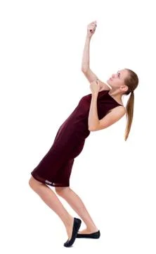 Back view of standing girl pulling a rope from the top or cling Stock Photos