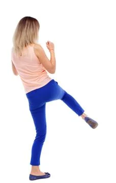 Back view of standing girl pulling a rope from top or cling to s Foto stock
