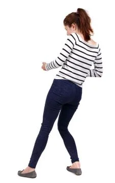 Back view of standing girl pulling a rope from top or cling to s Stock-Fotos
