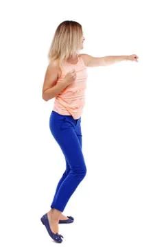 Back view of standing girl pulling a rope from top or cling to s Stock Photos