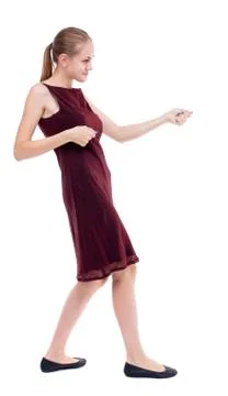 Back view of standing girl pulling a rope from the top or cling Stock Photos