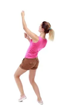 Back view of standing girl pulling a rope from the top or cling back view ... Stock Photos