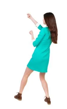 Back view of standing woman pulling a rope from the top or cling Stock Photos