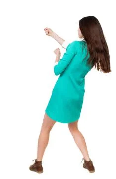 Back view of standing woman pulling a rope from the top or cling Stock Photos