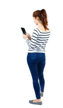 Back view of standing young beautiful  woman using a mobile phon Stock Photos