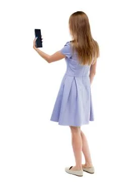 Back view of standing young beautiful  girl with tablet computer Stock Photos