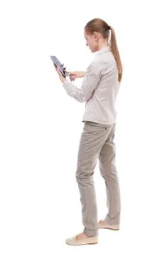 Back view of standing young beautiful  woman  and using a mobile Stock-Fotos