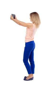 Back view of standing young beautiful  girl with tablet computer Stock-Fotos