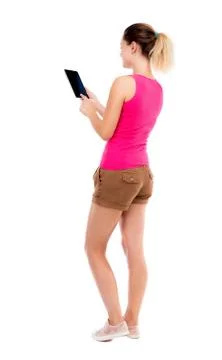 Back view of standing young beautiful  girl with tablet computer Stock Photos
