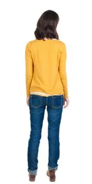 Back view of standing young beautiful  brunette woman in yellow Foto stock