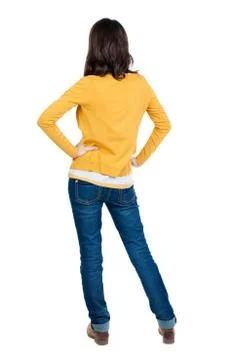 Back view of standing young beautiful  brunette woman in yellow Stock Photos