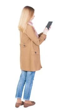 Back view of standing young beautiful  girl with tablet computer Stock Photos