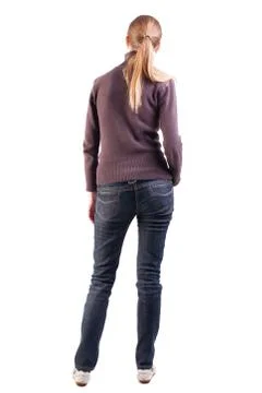 Back view of standing young beautiful  blonde woman in sweater Stock Photos