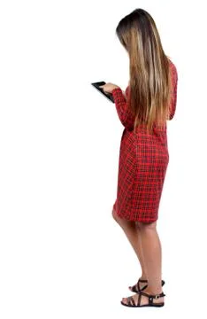 Back view of standing young beautiful  woman  and using a mobile Stock Photos