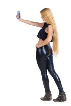 Back view of standing young beautiful  girl with tablet computer in the hands Stock Photos