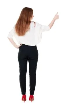 Back view of standing young redhead business woman showing thumb Stock Photos