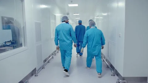 Back view of surgeons wearing protective masks and uniform walking Stock Footage 200855984