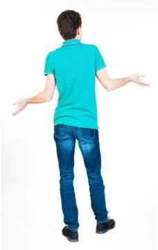 Back view of surprised brunette young man with hands up Foto stock