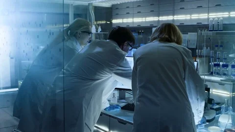 Back View of Team of Senior and Young Scientists Working on Problem Solution. Stock Footage 75527350