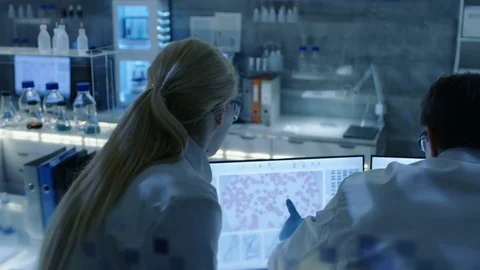 Back View of Team of Senior and Young Scientists Working on Problem Solution.  Stock Footage 75527435
