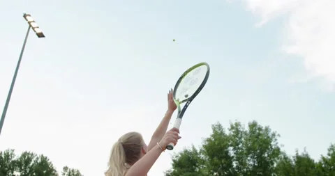 Back view of tennis player hitting the ball with strength to opponent on clay Stock Footage 159116926