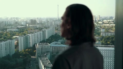 Back View of the Thoughtful Yong guy Standing in His Office, Contemplating Next Stock Footage 136819873