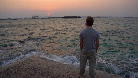 Back View of Thoughtful Young Man Contemplating While Looking at Sun Rising Stock Footage 126259082