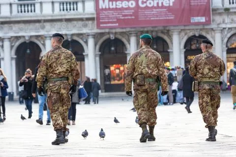 Back view of three anonymous men in military uniform Stock Photos