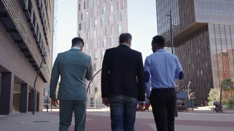 Back view three business men walking for city outside office in financial center Stock Footage 261341894